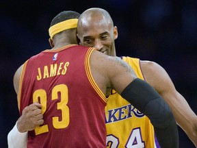 FILE - In this Jan. 15, 2015, file photo, Los Angeles Lakers guard Kobe Bryant, right, and Cleveland Cavaliers forward LeBron James hug before the start of an NBA basketball game, in Los Angeles. The Los Angeles Lakers have a new superstar -- L.A.-Bron. The four-time NBA MVP announced Sunday night, July 1, 2018, that he has agreed to a four-year, $154 million contract with the Lakers. "Welcome to the family (at)KingJames," Bryant said on Twitter . "(hash)lakers4life (hash)striveforgreatness."
