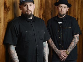 In this Tuesday, July 10, 2018, photo, Benji Madden, left, and his twin brother Joel Madden of the band Good Charlotte pose for a portrait, in Burbank, Calif. The city of Annapolis, Md. will hold a benefit concert on July 28 featuring the Maryland-based band to honor the five Capital Gazette employees killed in an attack in their newsroom.