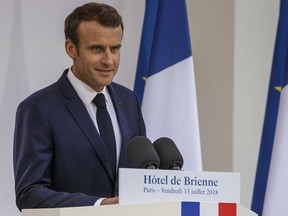 rance's President Emmanuel Macron delivers a speech after signing the armed forces annual law budget, at the Hotel de Brienne, in Paris, France, Friday, July 13, 2018. (Christophe Petit Tesson/Pool Photo via AP).