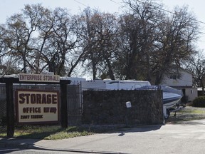 FILE - This Dec. 15, 2015, file photo, shows the entrance to a commercial storage unit facility is shown where two children were found dead in Redding, Calif. A 20-year-old man convicted of torturing, starving and beating two children whose bodies were found in a storage unit has been sentenced to three life sentences in prison.  A judge on Wednesday, July 11, 2018  sentenced Gonzalo Curiel in the 2015 killings of a 7-year-old boy and his 3-year-old sister. Curiel was also convicted of torturing their 9-year-old in their Salinas apartment.
