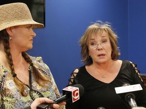 FILE - In this May 1, 2018, file photo, Brooke McGowan, left, and Ronda Vuillemont-Smith, right, of Oklahoma Taxpayers Unite!, talk with the media after they attempted to file a veto referendum petition which would negate the recent new taxes passed to fund a teacher pay raise in Oklahoma City. The group said Monday, July 2, 2018, they are abandoning their effort to roll back tax increases.