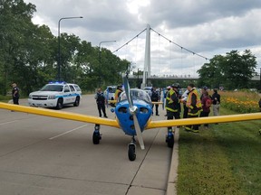 In this July 27, 2018, photo provided by Chicago Fire Department, a small plane that made an emergency landing on Lake Shore Drive, temporarily halting traffic at the beginning of evening rush hour, rests on the road in Chicago. Authorities say no vehicles were struck when the single-engine aircraft landed during the early stages of Friday evening's rush hour and the pilot wasn't injured. (Chicago Fire Department via AP)