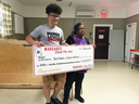 Tyrone MacInnis and Barb Reddick accept their Chase the Ace lottery prize, July 12, 2018.