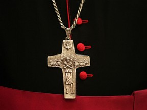 The cross of a priest is seen during mass at the Mother of Continuous Aid Church. The remains of what could be one of Rome's earliest churches have been discovered on the banks of the Tiber, close to where an epic battle led to Christianity being adopted as the Roman Empire's official religion.