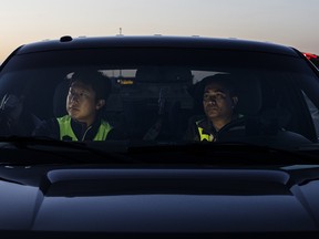 Members of Olds Citizens on Patrol, Jimmy Jeong, left and Sazzad Hossain drive around the town looking for signs of crime in July 2018.