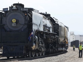 FILE - In this July 21, 2016, file photo, employees look on as Union Pacific Railroad's No. 844 steam locomotive arrives in rail yard in Denver. A woman who was taking photographs Saturday, July 21, 2018, of the steam locomotive was struck and killed after getting too close to the tracks in north suburban Denver.