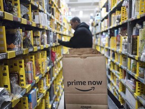Amazon announced today plans for a new fulfillment centre in Orleans, Ont., the eastern suburb of Ottawa. A clerk reaches to a shelf to pick an item for a customer order at the Amazon Prime warehouse in New York on Dec. 20, 2017.