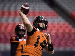 B.C. Lions quarterback Travis Lulay passes as quarterback Jonathon Jennings, back, watches before a pre-season CFL football game against the Winnipeg Blue Bombers in Vancouver, B.C., on Friday June 8, 2018. The B.C. Lions have a new starting quarterback. With Jonathon Jennings struggling, the Lions (1-2) have promoted veteran Travis Lulay to the No. 1 spot for Saturday's home game against the Winnipeg Blue Bombers.