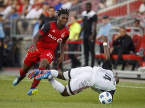 Toronto FC's Ayo Akinola battles for the ball with Ottawa Fury FC's Nana Attakora, right, during the first half of Canadian Championship soccer action in Toronto, Wednesday July 25, 2018. Born in Detroit to Nigerian parents and raised in Canada, Toronto FC forward Akinola helped the U.S. to the quarter-finals of the FIFA U-17 World Cup last year. But the 18-year-old???s international allegiance is not yet set in stone.