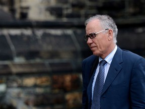 Senator Mac Harb arrives to the East Block of Parliament Hill in Ottawa on May 29, 2013. Mac Harb, a former Liberal senator who became a central figure in the Senate expense scandal, says he has settled a claim with Royal Bank over its role in the investigation into his Senate spending. An RCMP investigation into Harb's Senate expenses alleged his primary residence was "uninhabitable" for three years, and that he maintained a 0.01 per cent ownership stake in the house after selling the rest to a diplomat from Brunei who subsequently left Canada.