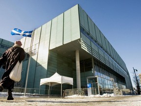 A man walks past the Grande Biblioteque library in Montreal on January 24, 2007. Montreal's Grande Bibliotheque has been dealing with a bedbug invasion for the past few weeks, but the library's executive director says she is confident it has a handle on the pest problem. Danielle Chagnon said today the situation was discovered about three weeks ago but is under control.