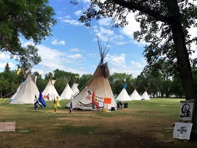 Teepees that were set up in protest across from the Saskatchewan legislature are staying put. The protest camp is seen near the provincial legislature in Regina on July 3, 2018. Saskatchewan's premier says that he has no plans to visit a camp that's been set up across from the provincial legislature since late February. Scott Moe says that he hasn't yet visited the camp and has never previously visited any protest in front of the legislature.