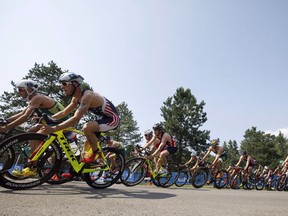 Athletes ride around a corner during the elite men's ITU World Triathlon Series in Edmonton, Alta., on Saturday July 29, 2017. The Alberta government is stepping up with $3.5 million for Edmonton when it hosts the ITU World Triathlon Grand Final in 2020. The grand final is a five-day competition featuring 3,500 competitors from 70 countries assisted by 1,500 volunteers.THE CANADIAN PRESS/Jason Franson