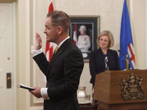 Alberta is eyeing big changes to its driver road tests -- and may grab them back from the private sector -- citing concerns on oversight and sky-high fees compared with the rest of Canada. Brian Malkinson is sworn in as the new Minister of Service Alberta during a cabinet shuffle in Edmonton on Monday, June 18, 2018.