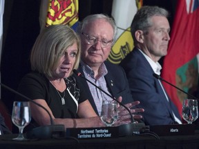 The province of Alberta is expanding a pilot project to ensure bus service to residents in rural areas. Alberta Premier Rachel Notley speaks at the closing news conference of the Canadian premiers meeting in St. Andrews, N.B., on Friday, July 20, 2018. Prince Edward Island Premier Wade MacLauchlan, centre, and Manitoba Premier Brian Pallister look on.