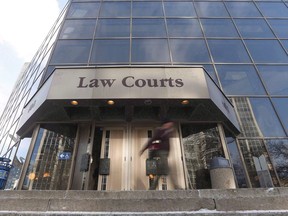 People enter the Law Courts in Winnipeg on February 5, 2018. A Winnipeg man who left his 89-year-old mother on the floor of their home, covered in her own feces and urine until she died, is scheduled to be sentenced today. Ronald Siwicki, a local musician, pleaded guilty in January to criminal negligence causing the death of his mother Elizabeth, who suffered from dementia.