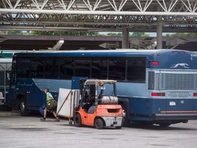 Package delivery firms say they are prepared to fill the gap when Greyhound Canada closes most of its Western Canada operations this October. A worker removes luggage from a Greyhound bus upon arrival in Vancouver on Monday, July 9, 2018.