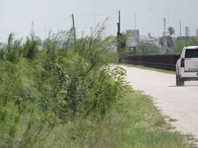 A U.S. Border Patrol vehicle drives along a fence line near the U.S.- Mexico border, Monday, June 25, 2018, in Hidalgo, Texas.