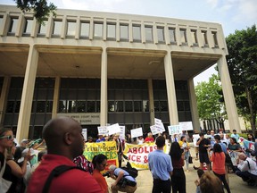 People hold a rally outside the Federal Courthouse in Bridgeport, Conn. on Wednesday, July 11, 2018. Lawyers for two immigrant children detained in Connecticut after being separated from their parents at the U.S.-Mexico border asked a federal judge on Wednesday to order that the girl and boy be reunited with their families.