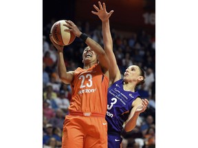 Connecticut Sun guard Layshia Clarendeon (23) is fouled by Phoenix Mercury guard Diana Taurasi (3) during the first half of a WNBA basketball game Friday, July 13, 2018, in Uncasville, Conn.