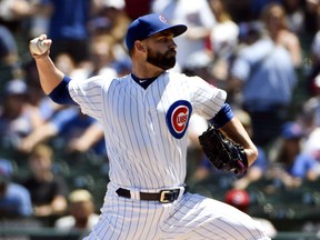 Chicago Cubs starting pitcher Tyler Chatwood (21) throws against the Cincinnati Reds during the first inning of a baseball game Saturday, July 7, 2018, in Chicago.