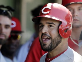Cincinnati Reds' Eugenio Suarez celebrates with teammates after hitting a two-run home run during the fourth inning of a baseball game against the Chicago Cubs Sunday, July 8, 2018, in Chicago.