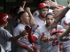 St. Louis Cardinals' Tommy Pham (28) celebrates his home run off Chicago Cubs starting pitcher Kyle Hendricks in the dugout during the second inning of a baseball game Thursday, July 19, 2018, in Chicago.