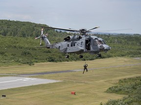 An RCAF CH-148 Cyclone maritime helicopter technician engages in a hoist exercise in Halifax on Friday, July 13, 2018.