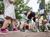 People lay flowers on Monday July 23, in remembrance of the victims in the shooting on Toronto’s Danforth Avenue that took place Sunday evening.