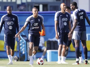 France's Kylian Mbappe jokes with teammates during a training session at the 2018 soccer World Cup in Glebovets, Russia, Monday, July 2, 2018.
