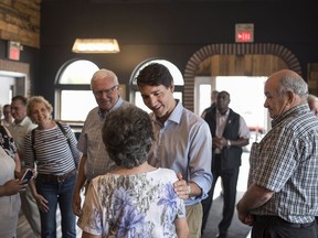 Prime Minister Justin Trudeau greets supporters while making a brief stop at Jimolly's Bakery & Cafe in Truro, N.S. on Tuesday, July 17, 2018.