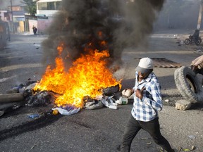 People protest over the cost of fuel in Port-au-Prince, Haiti, Friday, July 6, 2018. Major protests erupted Friday in Haiti as the government announced a sharp increase in gasoline prices, with demonstrators using burning tires and barricades to block major streets across the capital and in the northern city of Cap-Haitien.