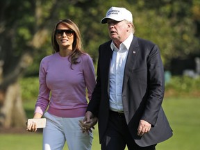 President Donald Trump and first lady Melania Trump walk on the South Lawn of the White House after disembarking Marine One, Sunday, July 1, 2018, in Washington. Trump is returning from a trip to his resort in Bedminster, N.J.