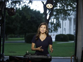 CNN White House correspondent Kaitlan Collins talks during a live shot in front of the White House, Wednesday, July 25, 2018, in Washington. Collins says the White House denied her access to President Donald Trump's Rose Garden statement with the European Union Commission president because officials found her earlier questions "inappropriate."