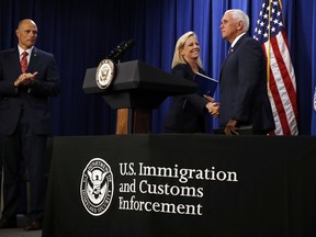 Vice President Mike Pence, right, shakes hands with Homeland Security Secretary Kirstjen Nielsen, next to Acting Director of U.S. Immigration and Customs Enforcement (ICE) Ronald Vitiello, as Pence arrives to speak at ICE Friday, July 6, 2018, in Washington.
