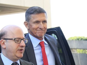 Former Trump national security adviser Michael Flynn, right, arrives at federal courthouse in Washington, Tuesday, July 10, 2018, for status hearing.