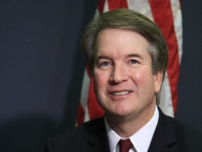 Supreme Court nominee Brett Kavanaugh glances at reporters during a meeting with Sen. James Lankford, R-Okla., on Capitol Hill in Washington, Thursday, July 19, 2018.