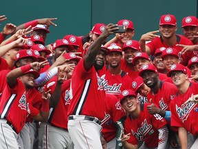 World Team manager David Ortiz (34) shoots a self portrait with his team before the All-Star Futures baseball game, Sunday, July 15, 2018, at Nationals Park, in Washington. The 89th MLB baseball All-Star Game will be played Tuesday.