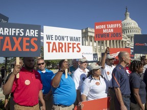 Americans who work for international auto companies demonstrate against trade tariffs they say will negatively impact U.S. auto manufacturing, on Capitol Hill in Washington, Thursday, July 19, 2018.