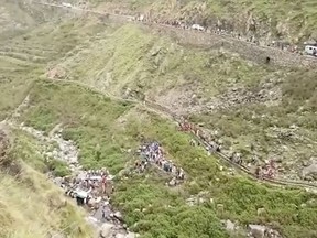 In this grab made from video provided by KK Productions, shows the area of a deadly bus accident in Uttarakhand's Paudi Garhwal district, northern India, Sunday, July 1, 2018. Chief Minister of Uttarakhand state Trivendra Rawat said the bus fell into a 700-foot (213-meter) deep gorge in the Himalayan foothills.