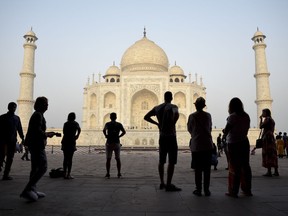 FILE - In this March 22, 2018 file photo, tourists visit India's famed monument of love, the Taj Mahal, in Agra, India. India's top court has on Wednesday, July 11, flayed the federal government for a second time within weeks for lethargy in taking steps to protect the Taj Mahal, the shining white monument to love. The Supreme Court orders the government to furnish full details of the steps being taken and action required for protecting the monument.