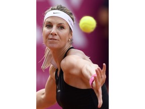 Mandy Minella of Luxembourg, returns a ball to Alize Cornet of France, during the final game at the WTA Ladies Championship tennis tournament in Gstaad, Switzerland, Sunday, July 22, 2018.