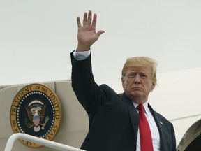 President Donald Trump waves as he boards Air Force One at Morristown Municipal Airport, in Morristown, N.J., Sunday, July 22, 2018, en route to Washington.