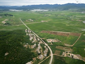 North Korean landscape is visible from the window of the plane carrying U.S. Secretary of State Mike Pompeo as it arrives at Sunan International Airport in Pyongyang, North Korea, Friday, July 6, 2018. Pompeo is on a trip traveling to North Korea, Japan, Vietnam, Abu Dhabi, and Brussels.