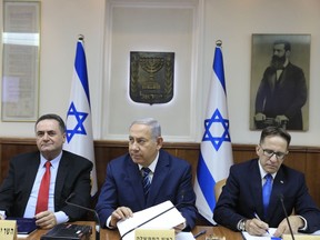 Israeli Prime Minister Benjamin Netanyahu, center, attends a cabinet meeting in Jerusalem Sunday, July 1, 2018.