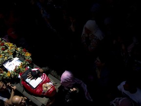 Palestinian mourners carry the body of Arkan Mezeher, 15, during his funeral in Deheisha refugee camp, near the West Bank city of Bethlehem, Monday, July 23, 2018. Mezher was fatally shot in the chest when clashes erupted during an Israeli military arrest raid on the camp.
