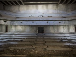 This Monday, June 25, 2018, photo shows the plenum hall of what was to be a Palestinian parliament in Abu Dis, West Bank. This decrepit building, built during the heyday of Israeli-Palestinian peace talks in the 1990s, was meant to serve the Palestinian parliament. Today, it is a grim reminder of dashed Mideast peace hopes and what might have been.