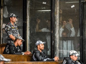 Members of Egypt's banned Muslim Brotherhood are seen inside a glass dock during their trial in the capital Cairo on July 28, 2018.