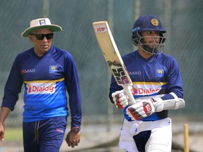 Sri Lanka's batsman Kusal Mendis right, and coach Chandika Hathurusingha attend a training session ahead of their second test cricket match against South Africa in Colombo, Sri Lanka, Thursday, July 19, 2018.