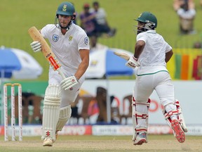 South Africa's Theunis de Bruyn, left, and Temba Bavuma run between wickets during the fourth day's play of their second test cricket match against Sri Lanka in Colombo, Sri Lanka, Monday, July 23, 2018.